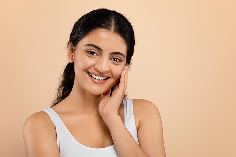 Beautiful Indian woman smiling after a facelift.